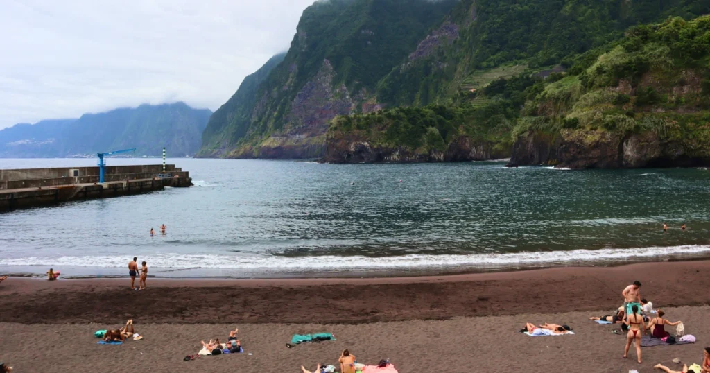 Seixal black sand beach with tourists